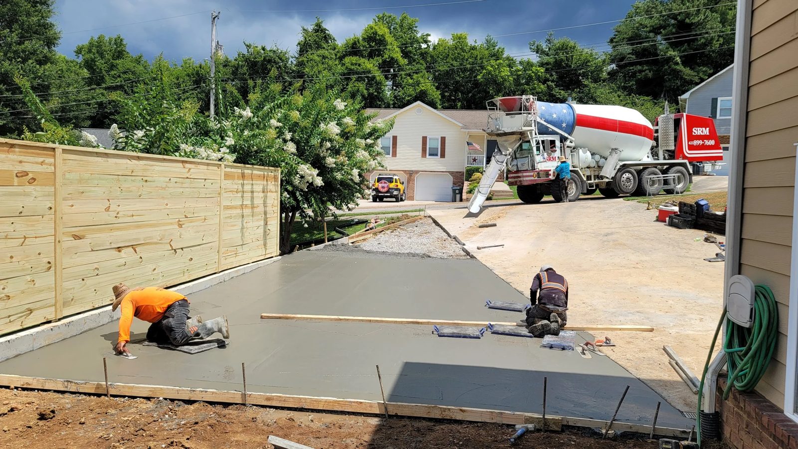 HGS crew finishing a fresh concrete driveway pour at a Chattanooga home